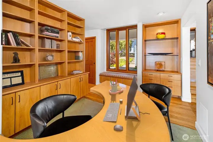 Dedicated office or library space with custom built-ins and warm wood finishes, ideal for work, study, or quiet retreat.