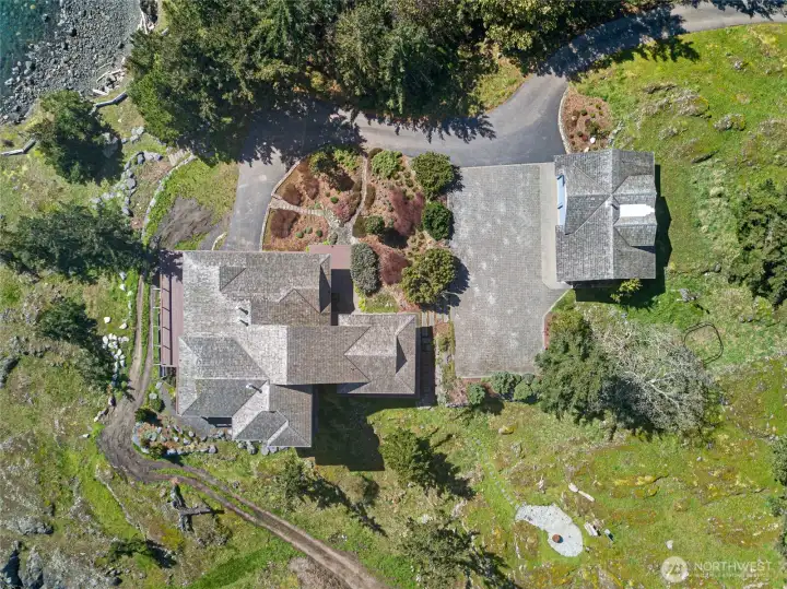 Thoughtfully designed layout showcasing the main residence, detached garage, and ADU, all set within beautifully landscaped grounds overlooking the water.