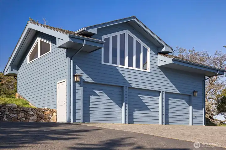 Detached 3-car garage with upper-level ADU, offering versatile space for guests, workspace, or income-producing potential in a premier waterfront setting.