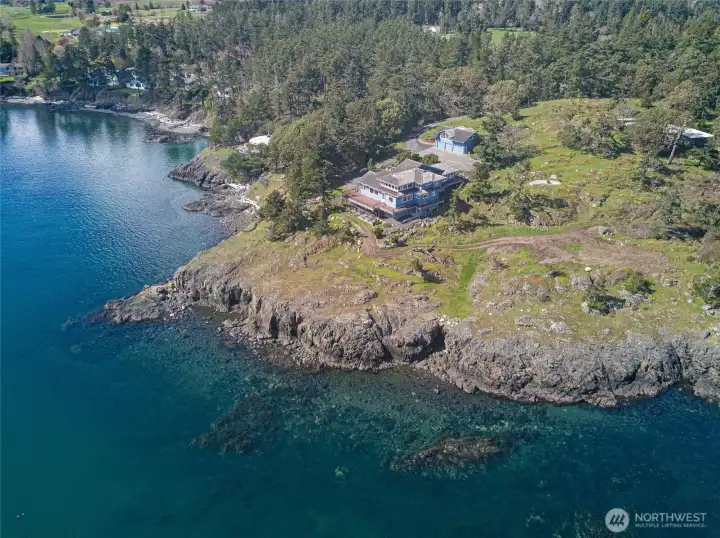Perched above the shoreline, the residence enjoys commanding views and direct access to the water, blending natural beauty with refined island living.