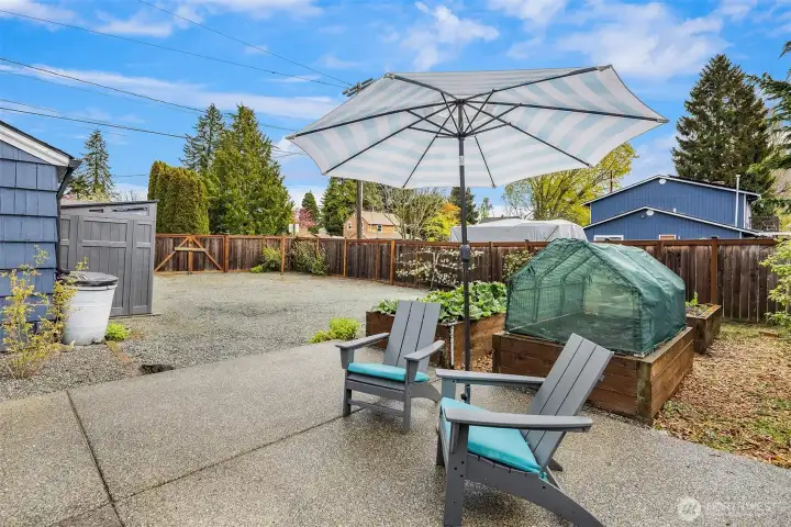 Raised planters for the healthy rhubarb and other vegetables, espalier fruit trees soaking the sun, and blueberry/raspberry patches.