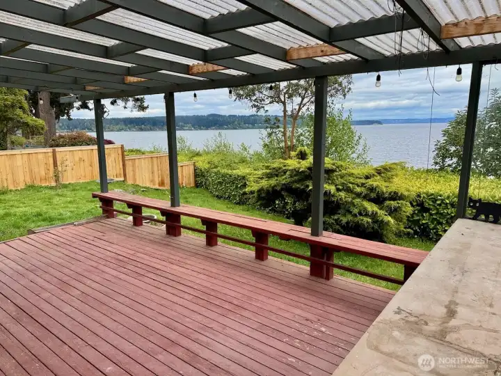 The covered deck with built-in seating.