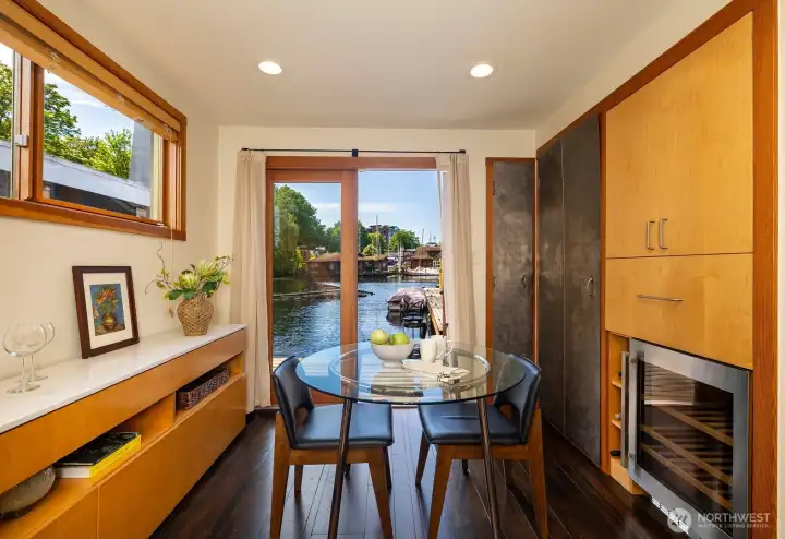 Eating space right off kitchen with french doors to the lake: beverage refrigerator & laundry to the right