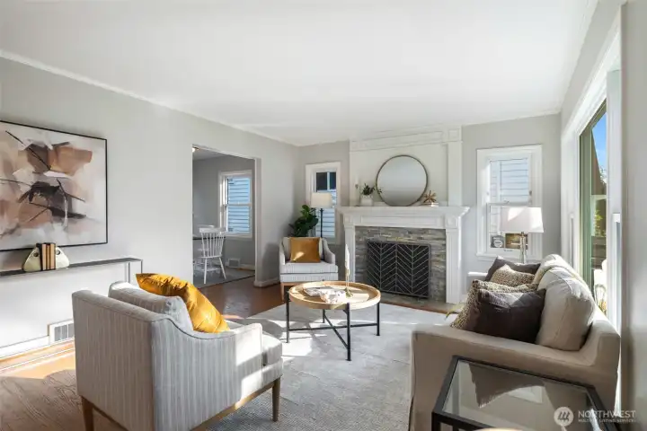 This bright and sunny living room is anchored by a fireplace with original hardwoods throughout the main level.