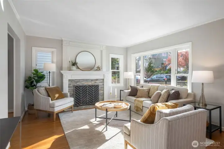 Stunning fireplace and custom mantle with sunny west facing windows to invite the light throughout.