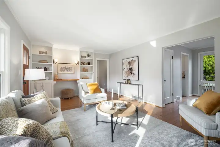 Custom built-ins and lighting in the living room open to the formal dining room.