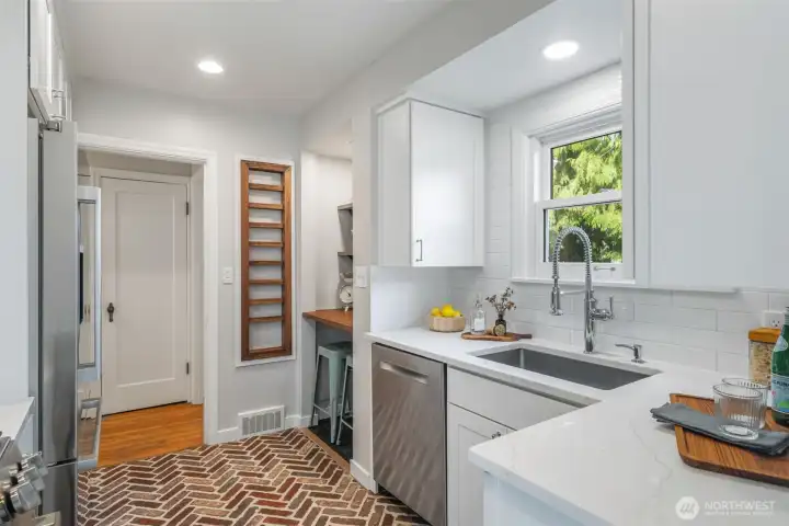 Updated kitchen with special touches, like the oak spice cabinet shown here, and a great window overlooking the deck and  backyard oasis.