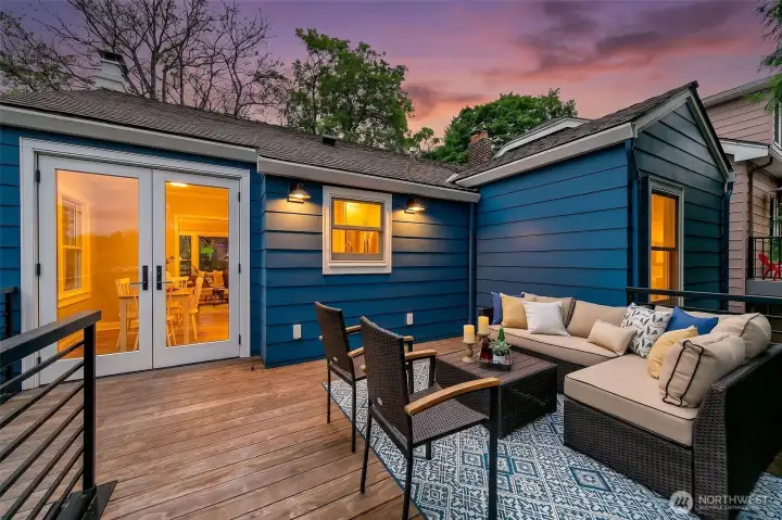 The kitchen window overlooks outdoor dining and retreat.