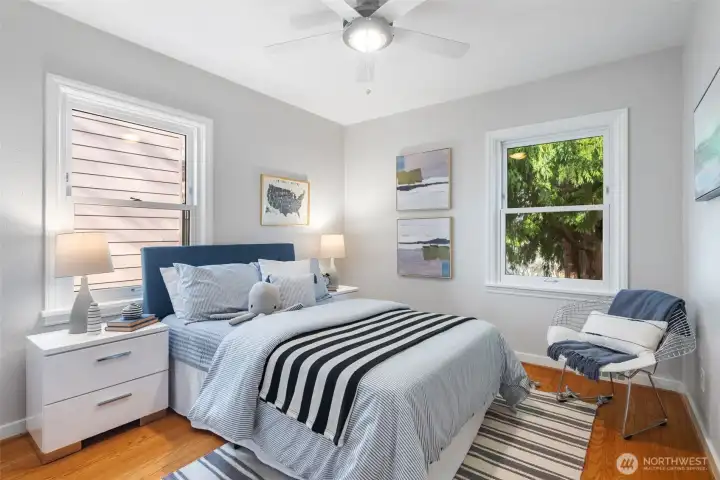 2nd bedroom on the main floor has corner windows and original hardwoods.
