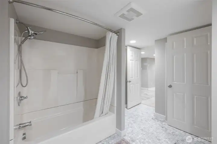 Spacious bath with tiled floors, updated and well designed with 2 entries.
