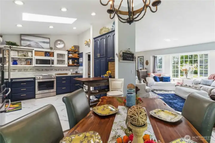 View from dining room with living room to the right and kitchen on the left