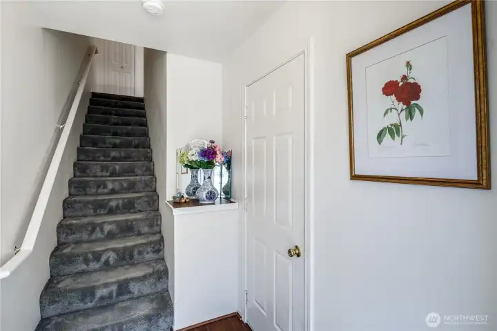 Front Foyer welcomes you and invites you to ascend to living spaces or enter into garage and access the extra finished room.