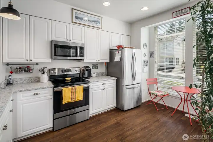 Kitchen has been refreshed with newer appliances and quartz countertops.  Note the extra nook area by window to enjoy your morning coffee.