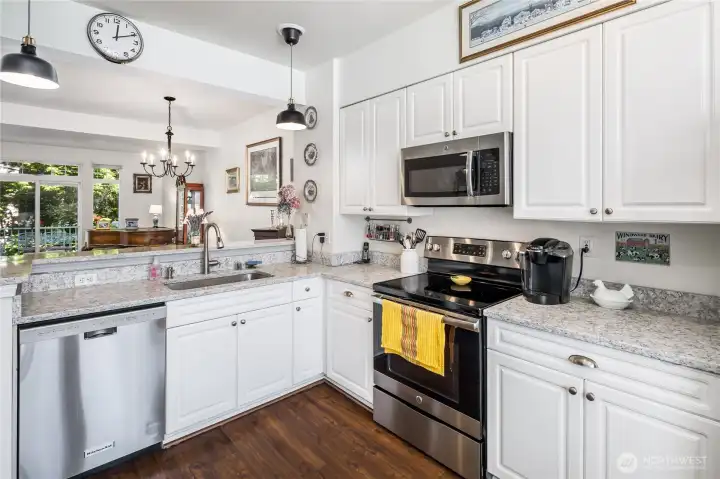 Kitchen features eating bar and opens to dining area and greatroom.