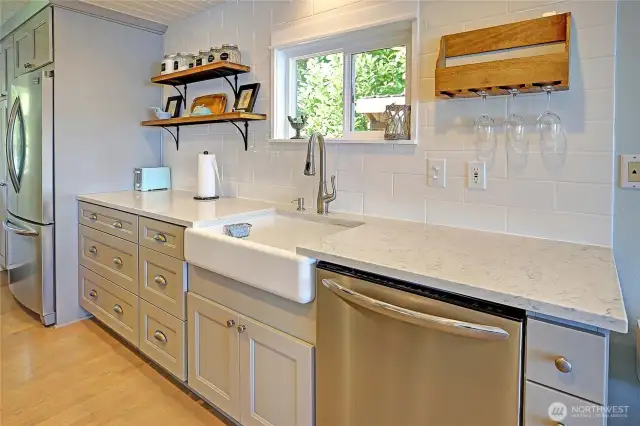 Farm house sink, quartz counters, SS appliances, cabs galore....this kitchen is truly gorgeous!