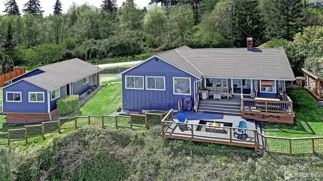 Double lot w/beautiful grounds surround this extensively renovated HIGH bank home on the desirable north end of this wonderful island.  Main home features 2 bedrooms, 2 baths + fun double "bunk room". Stunning HIGH end kitchen + cozy living spaces with stunning views. Guest cottage + ABUNDANT 2+ car garage. Bring your boat, toys....or add on in any way you choose!