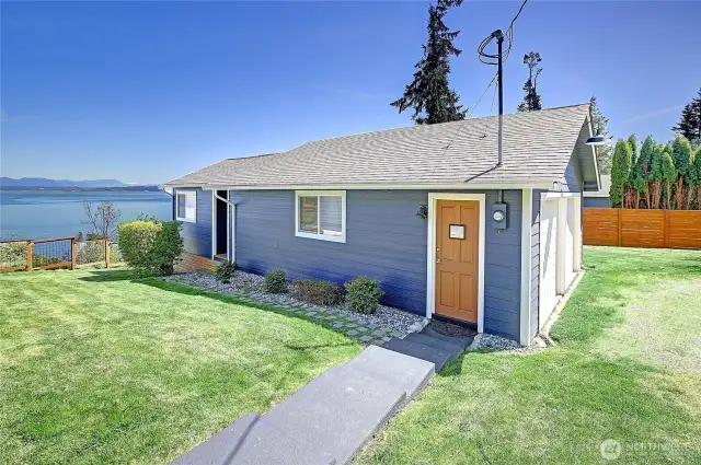 Steps away from the main home is the "guest cottage" and garage. Surrounded with green spaces, spectacular sound + mountain views and lot's of parking too!
