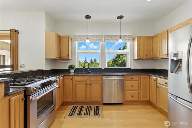 Beautiful kitchen with wood flooring, stainless steel appliances, and granite countertops
