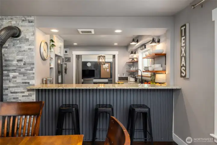 Bar to kitchen beyond provides a more casual dining option.