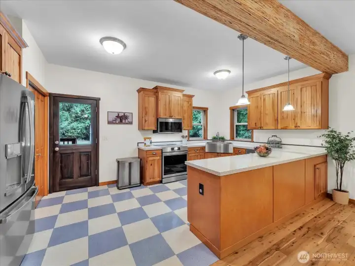 Kitchen with newer stainless steel appliances and access to the covered back porch to the back yard.