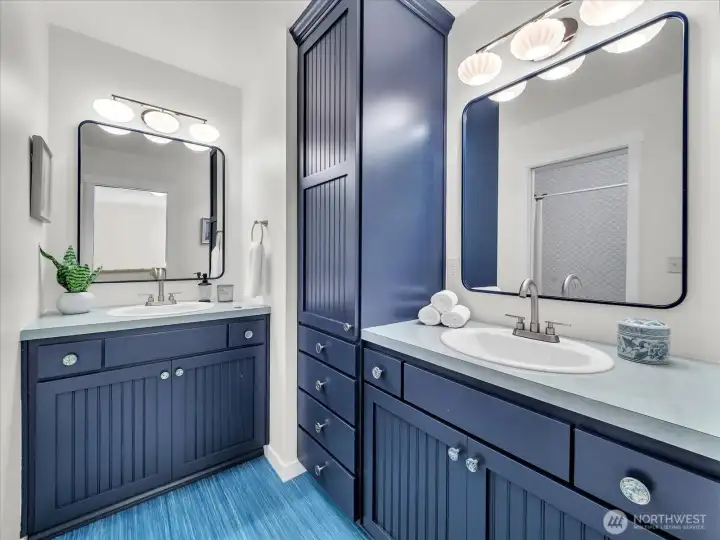 Main upstairs full bath includes two sinks and separate shower/tub and toilet section.