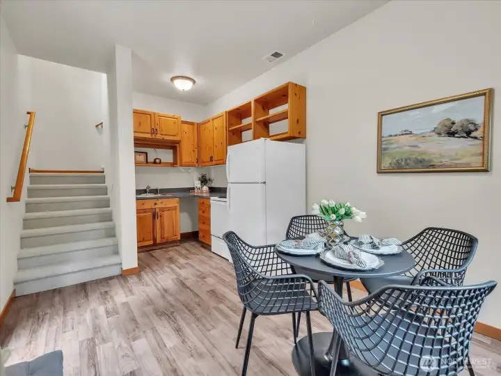 Second kitchen with eating space. Private entry is to the left, before the stairs.  Stairs lead up to the bonus room and the rest of the 2nd floor.  A door can be closed between the main house and this area.