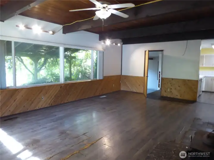 The living room with high ceilings and wood beams.