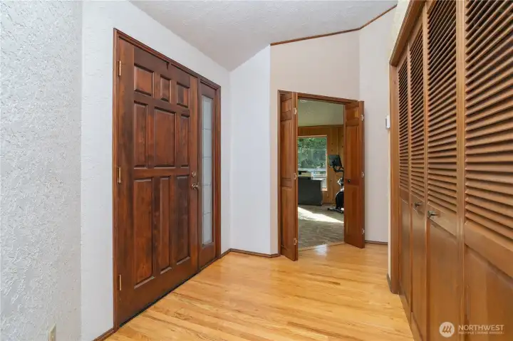 Main entrance into home showing a large foyer, ample coat closets. Entrance into 1st bedroom to the left of entrance.