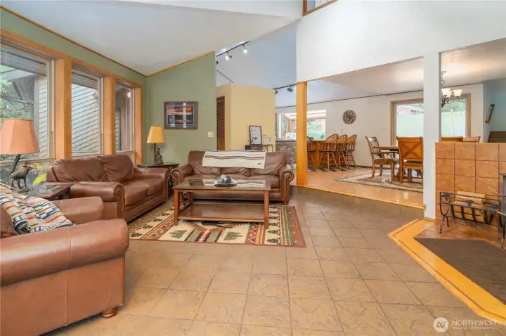 Main living space with wood stove & high ceilings to the upstairs loft.