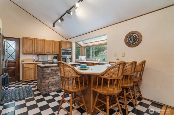 Kitchen with beautiful atrium window at the sink. Peninsula adding to usable counter space as well as eating bar. Dont forget the double oven!