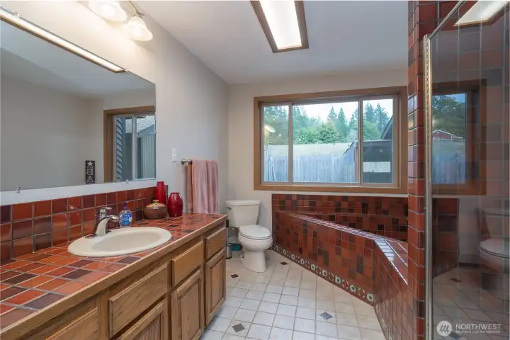 First hallway bathroom with large soaking tub, walk in shower and large linen closet.