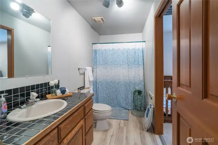 Second hallway bathroom with shower/tub combo and door to 2nd bedroom. Could be used as a guest suite.