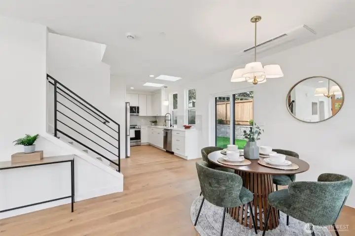 Living and dining rooms flow to kitchen. Glass doors open to private fence back yard - great space for entertaining