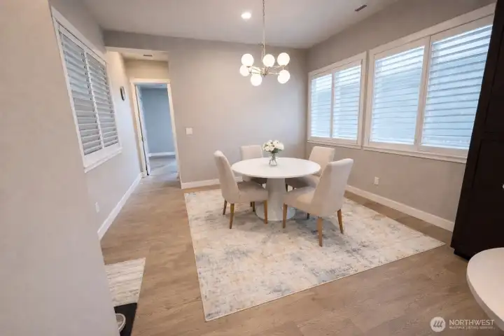 This space "behind" the kitchen can be used as ANOTHER dining space (this house offers so many options for eating / dining areas, it's really fabulous. Use it formally or in contemporary style (as in this AI version) or use it as home-management /office space.