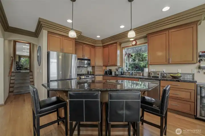 Granite countertops and stainless steel appliances adorn the kitchen.