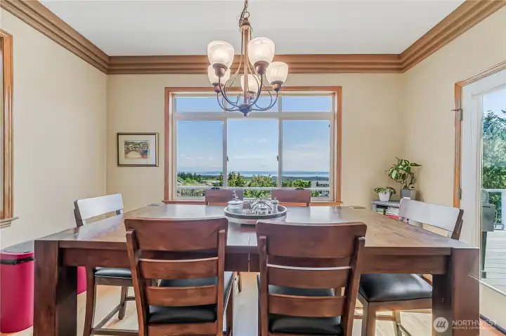 Open to the expansive deck and kitchen, the dining room is the perfect place to enjoy your meals.