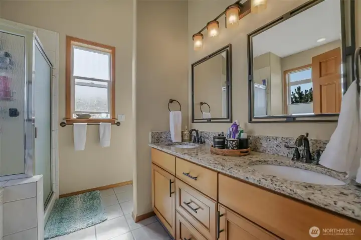 The 5-piece ensuite features double sinks, shower and soaking tub.