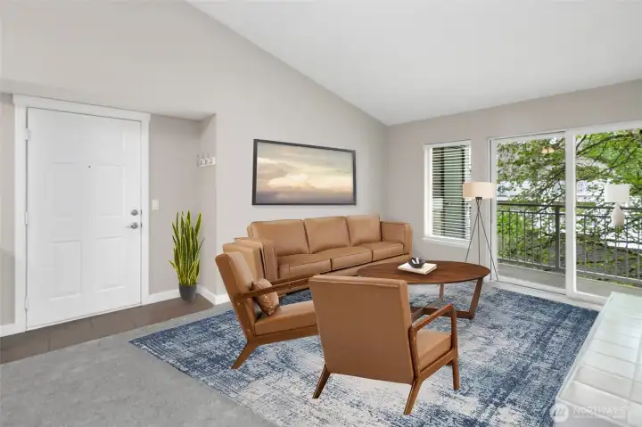 A beautiful living space with doors to the deck with a beautiful tree to enjoy.