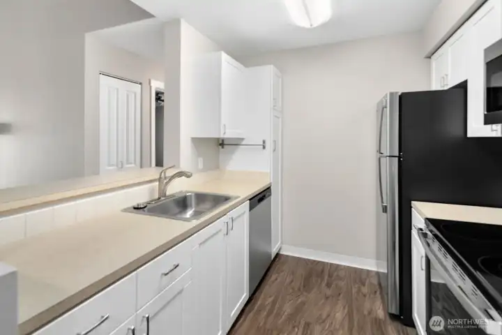 Kitchen with new appliances, refreshed cabbinets, new flooring and paint.