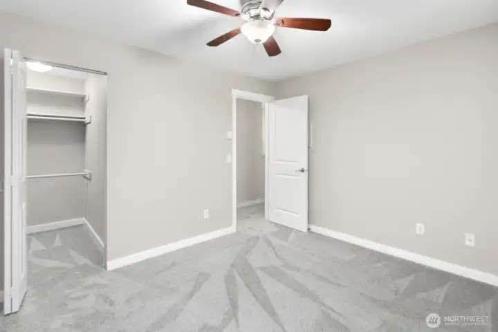 Bedroom with new flooring and walk in closet.
