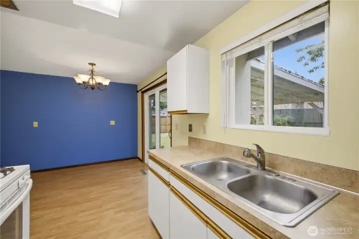 Functional kitchen space with a window overlooking the backyard. Functional kitchen space with a window overlooking the backyard.