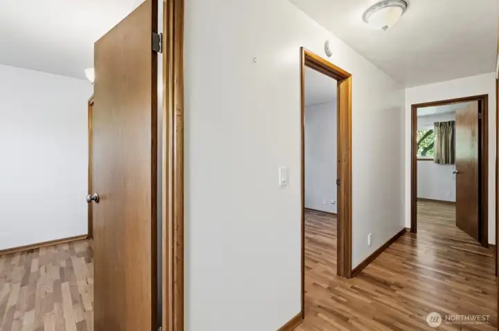 beautiful original hardwood floors continue down the hall way and into the bedrooms.