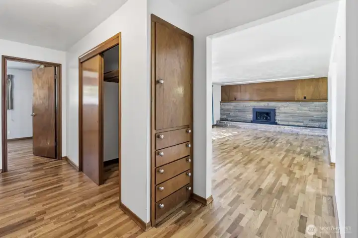 hallway view with gorgeous builtins and more closet space.