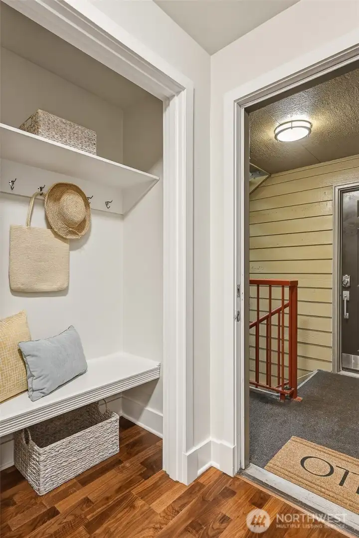 Entry closet with bench, hooks, and shelves keeps everything organized Entry closet with bench, hooks, and shelves keeps everything organized