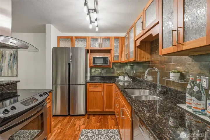 Stainless steel appliances include a four-door refrigerator and smooth-top range Stainless steel appliances include a four-door refrigerator and smooth-top range