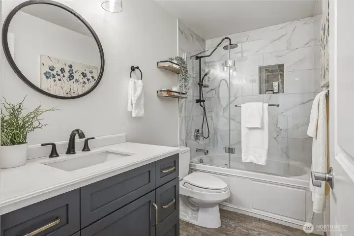 Full bath features a tiled shower and sleek black fixtures for a modern aesthetic Full bath features a tiled shower and sleek black fixtures for a modern aesthetic