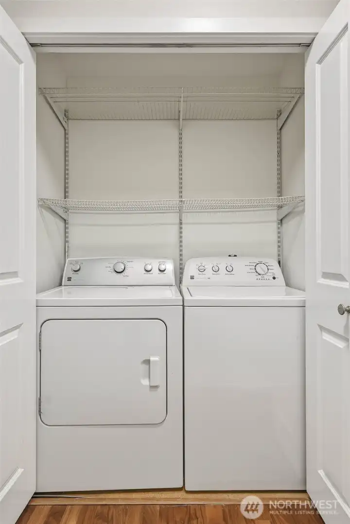 Laundry closet features a full-size washer and dryer plus shelving for supplies and extra storage Laundry closet features a full-size washer and dryer plus shelving for supplies and extra storage