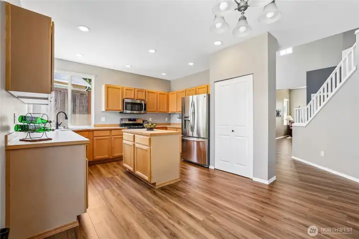 Great island kitchen with stainless steel appliances, extensive LVP flooring, pantry closet, gas range, corner sink with big windows overlooking the backyard Great island kitchen with stainless steel appliances, extensive LVP flooring, pantry closet, gas range, corner sink with big windows overlooking the backyard