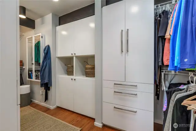 Primary walk-in closet.  Lower cabinets have baskets with a pass-through to the laundry room.  Great design!