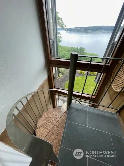 Let's head downstairs from the main level. Cork stairway to the lower level with a view as well!